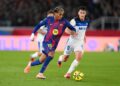 FC Barcelona and Deportivo Alavés players battling for possession in a LaLiga match